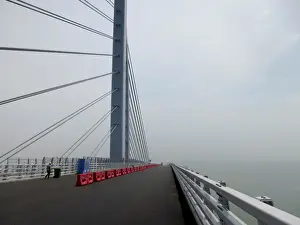 A worker walks on the Hong Kong-Zhuhai-Macau bridge under construction in Zhuhai