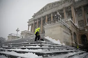 Prints of Workers clear the steps of the House of Representatives on Capitol Hill in Washington, U.S. March 21, 2018. REUTERS/Aaron P. Bernstein USA Prints: Workers clear the steps of the House of Representatives on Capitol Hill in Washington
