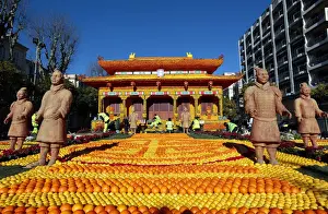 Workers put the final touches to a replica of the Forbidden City made with lemons
