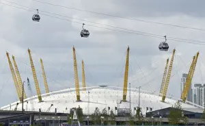Workers sit in gondolas as they perform tests on the new cable car link across
