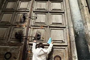 Prints of A worshipper touches the closed doors of the Church of the Holy Sepulchre in Jerusalems Old City February 27, 2018. REUTERS/Ammar Awad Israel Prints: A worshipper touches the closed doors of the Church of the Holy Sepulchre in Jerusalem s