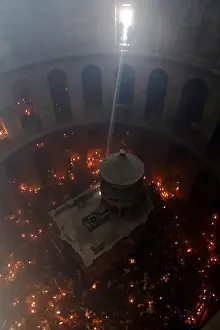 Worshippers hold candles as they take part in the Christian Orthodox Holy Fire ceremony