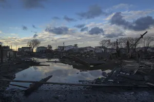 The wreckage of homes devastated by fire and the effects of Hurricane Sandy are seen in The wreckage of homes devastated by fire and the effects of Hurricane Sandy are seen in