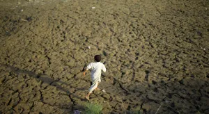 Pakistan Prints: A young flood victim runs as he plays at a relief camp in Mohib Banda near Charsadda